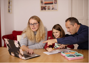 Parent helping child study at home